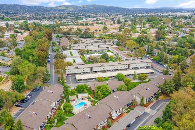 985 S Idaho St Unit 46, La Habra, CA 90631 - aerial view of property and surrounding area with mountains and a pool