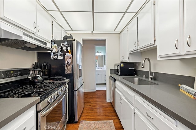 985 S Idaho St Unit 46, La Habra, CA 90631 - kitchen with appliances with stainless steel finishes, under cabinet range hood, a sink, and white cabinetry