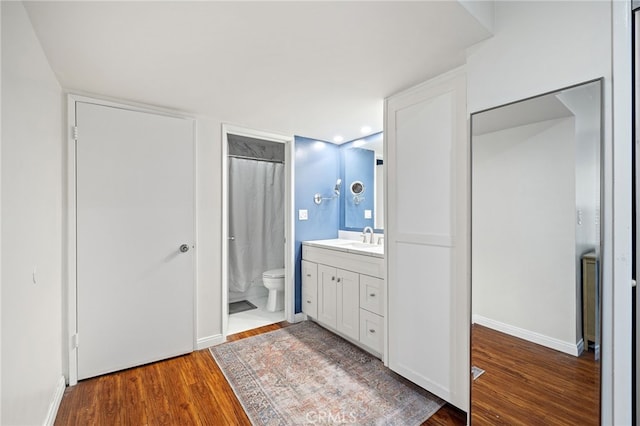 985 S Idaho St Unit 46, La Habra, CA 90631 - bathroom with wood finished floors, toilet, vanity, and baseboards