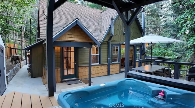 810 Lake Dr, Lake Arrowhead, CA 92352 - back of house with an outdoor hot tub and roof with shingles