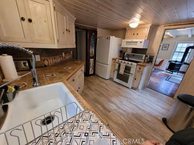 810 Lake Dr, Lake Arrowhead, CA 92352 - kitchen with white appliances, wooden counters, wood ceiling, light wood-style flooring, and a sink