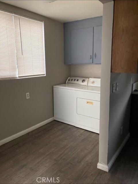 2404 E California, Bakersfield, CA 93307 - clothes washing area featuring separate washer and dryer, baseboards, and dark wood-style flooring
