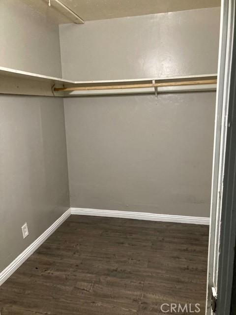 2404 E California, Bakersfield, CA 93307 - walk in closet featuring dark wood-type flooring