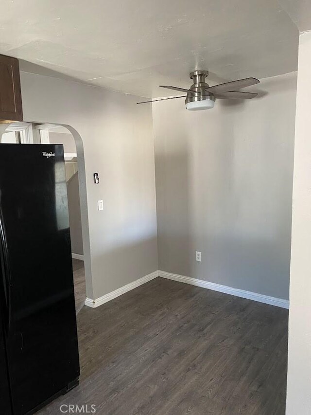 2404 E California, Bakersfield, CA 93307 - unfurnished dining area featuring ceiling fan, arched walkways, baseboards, and dark wood-type flooring