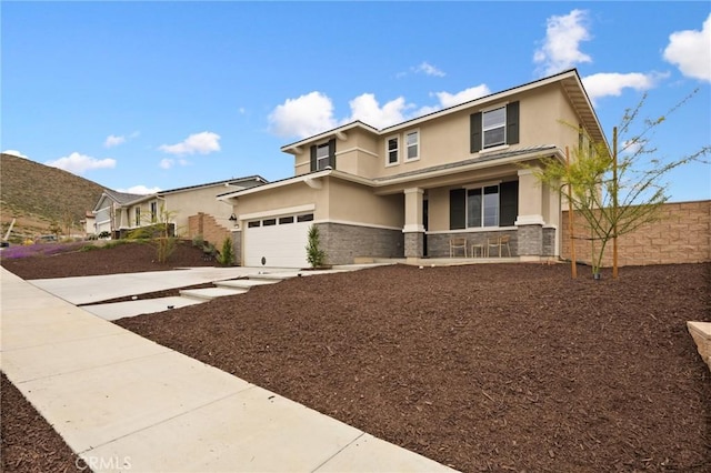 31768 Constellation Dr, Menifee, CA 92586 - view of front of home featuring stucco siding, stone siding, a porch, driveway, and fence