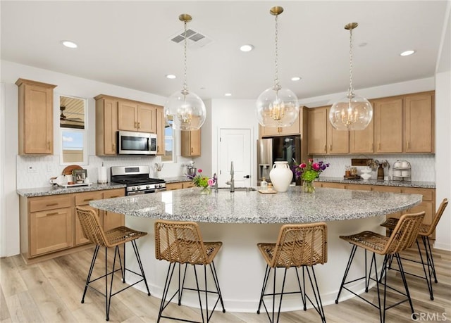 31768 Constellation Dr, Menifee, CA 92586 - kitchen with stainless steel appliances, a sink, backsplash, a chandelier, and recessed lighting