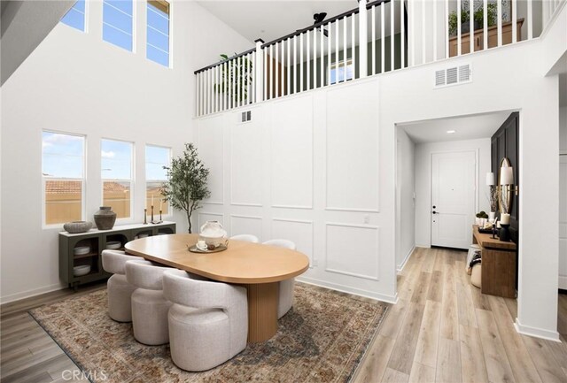 31768 Constellation Dr, Menifee, CA 92586 - dining room with a high ceiling, healthy amount of natural light, light wood-style floors, and baseboards