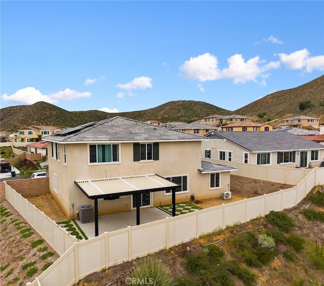 31768 Constellation Dr, Menifee, CA 92586 - rear view of house featuring a mountain view, stucco siding, a fenced backyard, and central AC