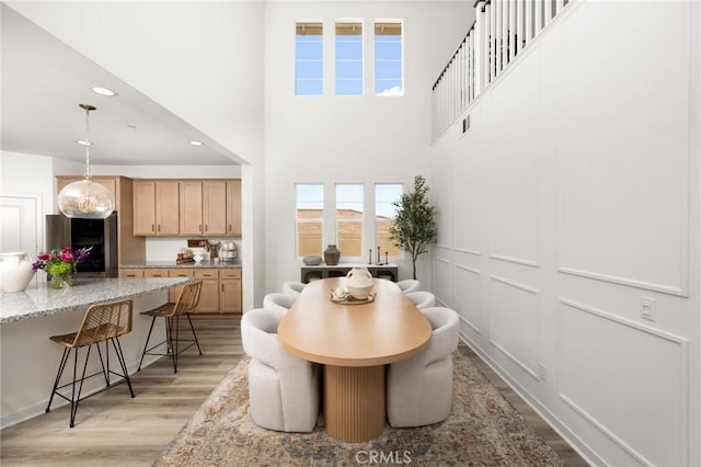 31768 Constellation Dr, Menifee, CA 92586 - dining area with light wood-style floors, recessed lighting, and a high ceiling