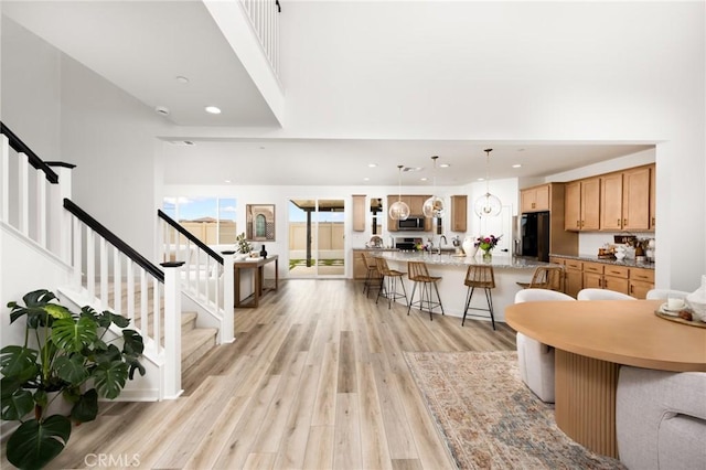 31768 Constellation Dr, Menifee, CA 92586 - living room with light wood finished floors, stairs, recessed lighting, and a high ceiling