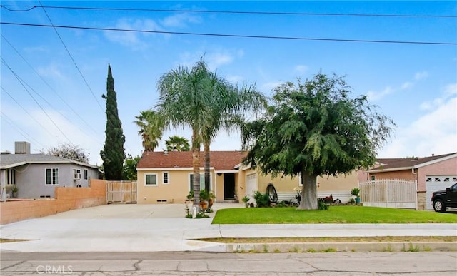 10005 Elwood Ave, Fontana, CA 92335 - single story home with stucco siding, driveway, fence, and a front yard