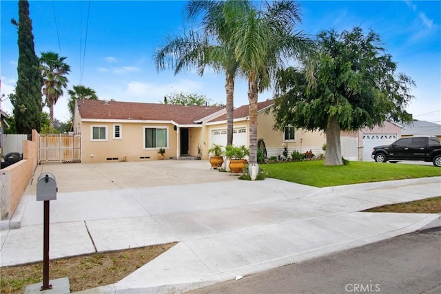 10005 Elwood Ave, Fontana, CA 92335 - ranch-style house with a front lawn, stucco siding, driveway, and an attached garage