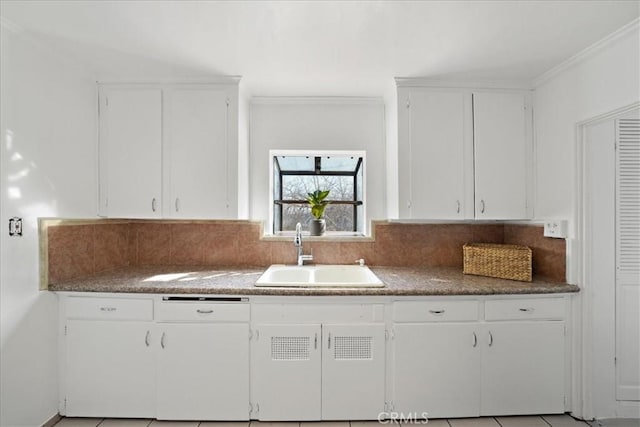 1745 College View Pl, Los Angeles, CA 90041 - kitchen featuring crown molding, white dishwasher, white cabinetry, a sink, and backsplash