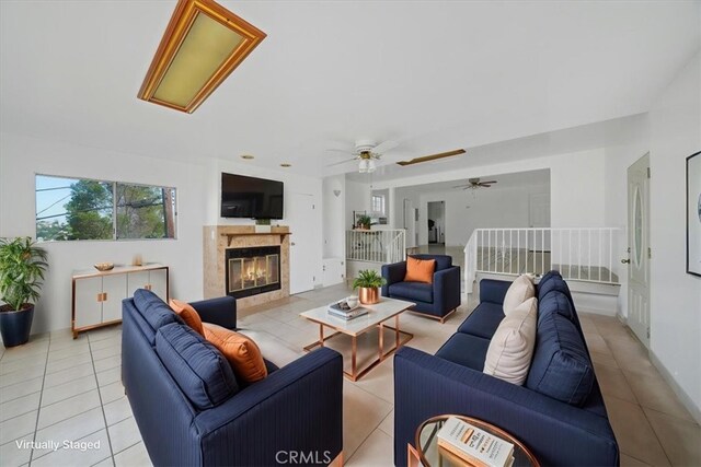 1745 College View Pl, Los Angeles, CA 90041 - living room with light tile patterned floors, ceiling fan, and a fireplace
