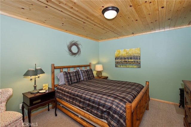 bedroom featuring wood ceiling, baseboards, and carpet