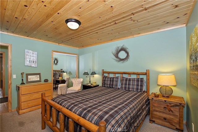 carpeted bedroom featuring wood ceiling, baseboards, and a closet