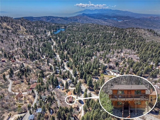 drone / aerial view featuring a view of trees and a mountain view