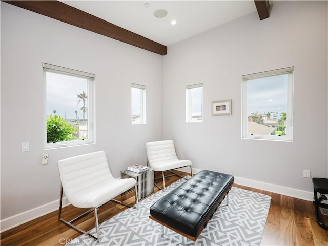 sitting room with recessed lighting, beamed ceiling, baseboards, and wood finished floors