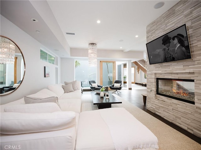 living room with an inviting chandelier, a multi sided fireplace, visible vents, and recessed lighting