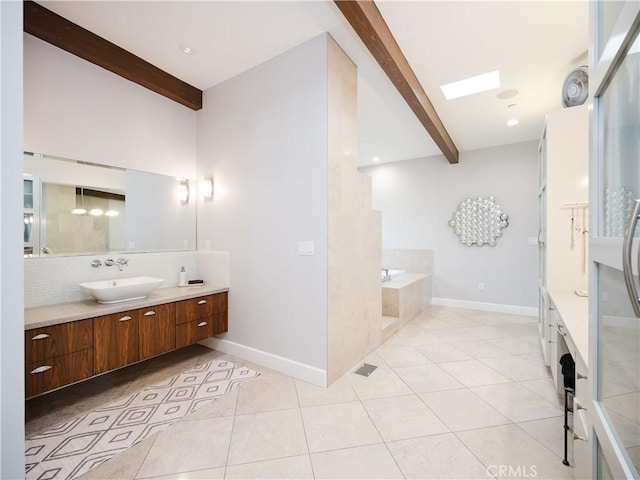 full bathroom featuring a garden tub, tile patterned flooring, beamed ceiling, decorative backsplash, and vanity