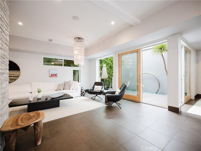 tiled living room with beamed ceiling, a chandelier, and recessed lighting
