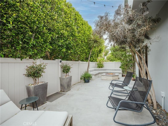 view of patio with a fire pit and a fenced backyard