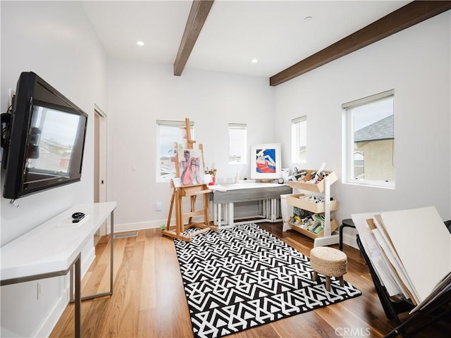 interior space with baseboards, beamed ceiling, recessed lighting, and wood finished floors