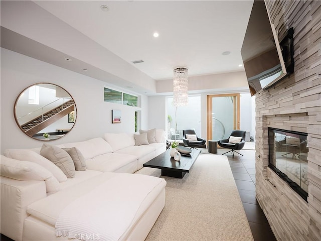 living room with recessed lighting, a stone fireplace, an inviting chandelier, visible vents, and tile patterned flooring