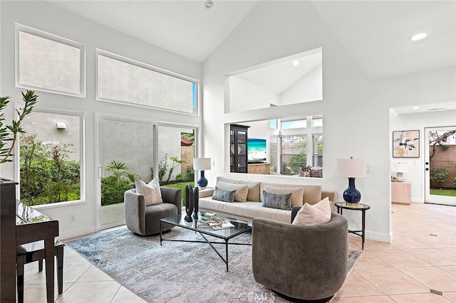 living room featuring baseboards, recessed lighting, light tile patterned flooring, and high vaulted ceiling