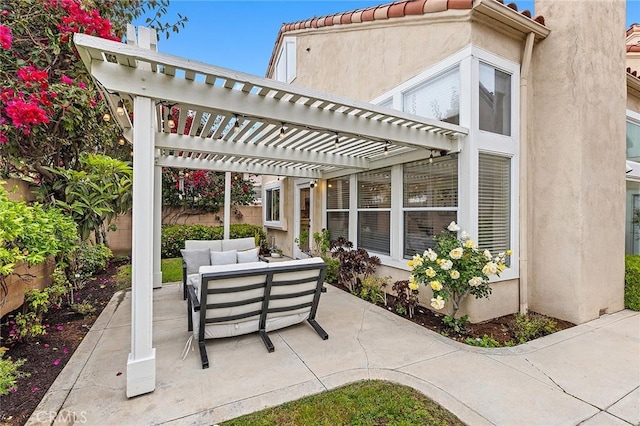 view of patio with an outdoor living space, fence, and a pergola