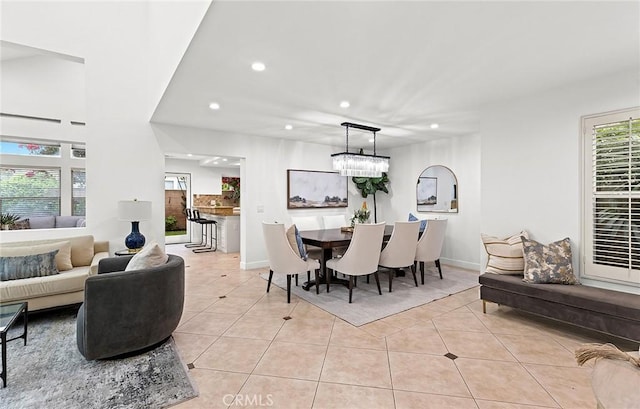 dining area with recessed lighting, baseboards, light tile patterned floors, and a chandelier
