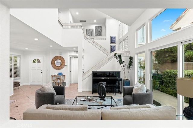 living room featuring tile patterned flooring, stairway, baseboards, a high ceiling, and recessed lighting