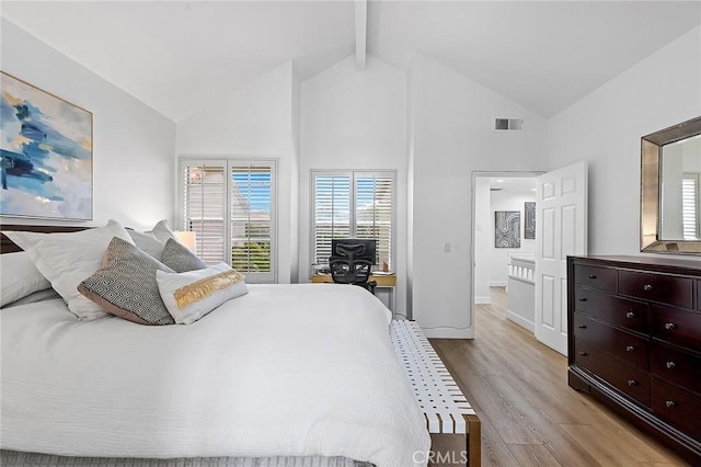 bedroom featuring visible vents, light wood-type flooring, beam ceiling, high vaulted ceiling, and baseboards
