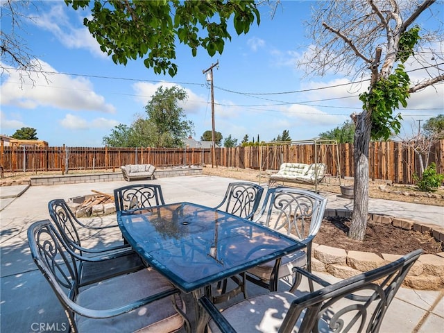 view of patio / terrace with outdoor dining area, a fenced backyard, and an outdoor hangout area