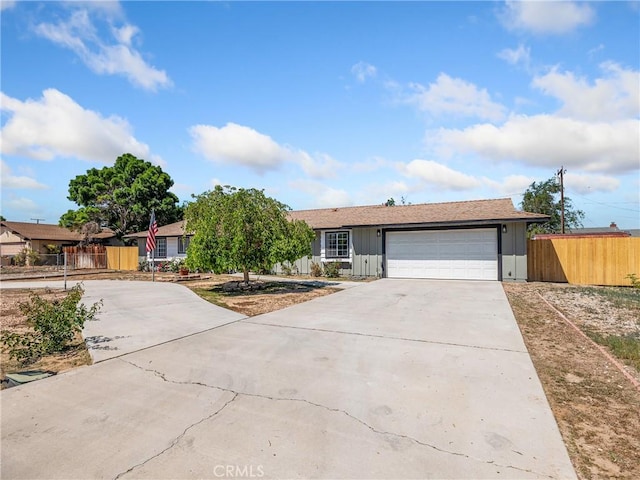 single story home featuring an attached garage, board and batten siding, fence, and driveway