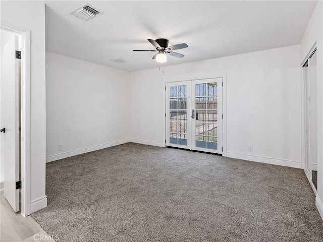 unfurnished bedroom featuring carpet floors, baseboards, and visible vents