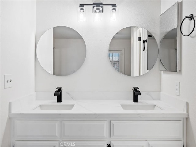 bathroom with a sink and double vanity
