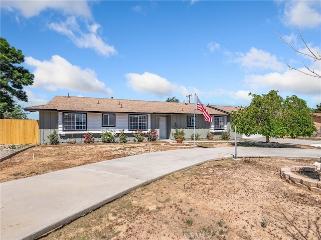 ranch-style house with fence and driveway