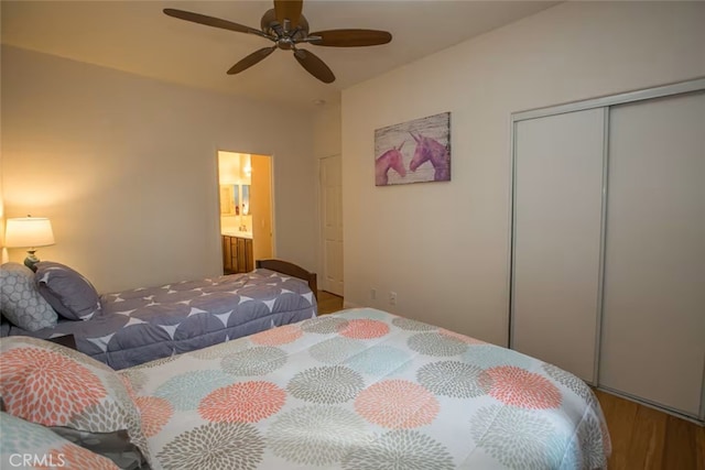 bedroom featuring a closet, ceiling fan, wood finished floors, and ensuite bathroom