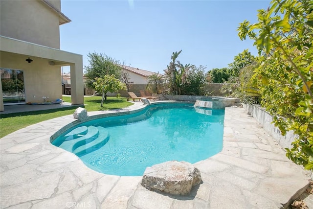 view of swimming pool with a yard, a pool with connected hot tub, a fenced backyard, and a patio area