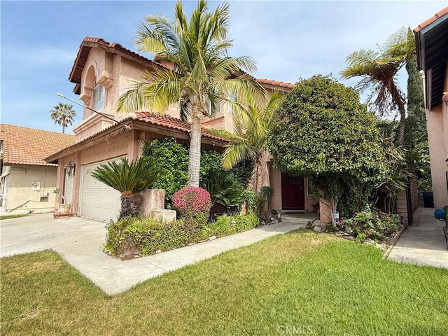 mediterranean / spanish-style house featuring a front lawn, stucco siding, an attached garage, driveway, and a tile roof
