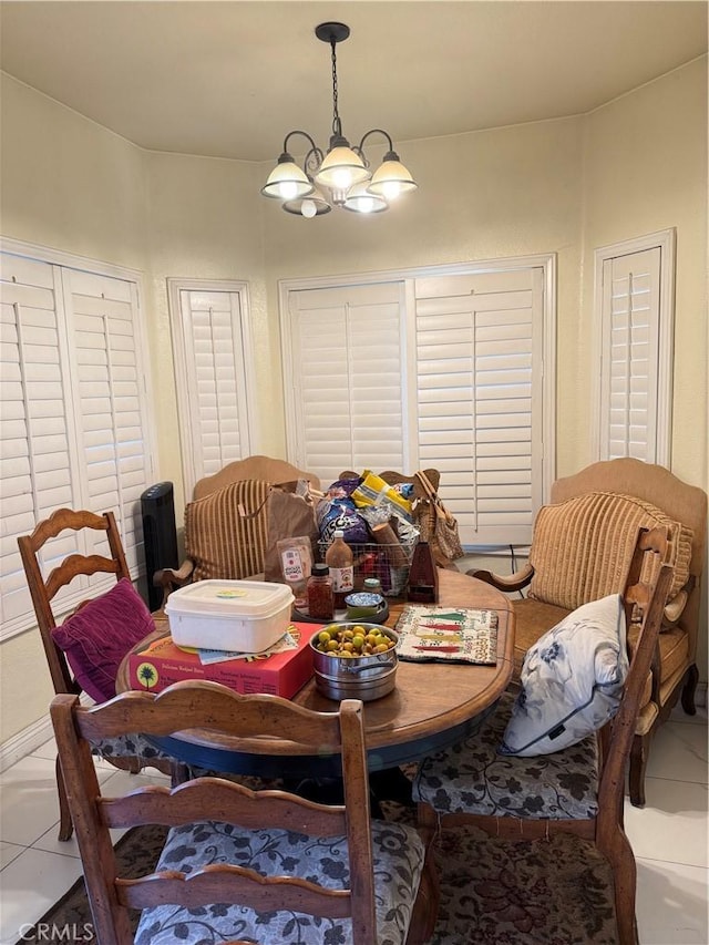 dining area featuring an inviting chandelier and tile patterned flooring