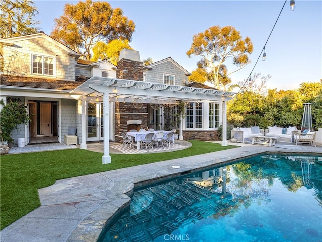 back of property featuring a pergola, an outdoor pool, french doors, an outdoor hangout area, and a yard