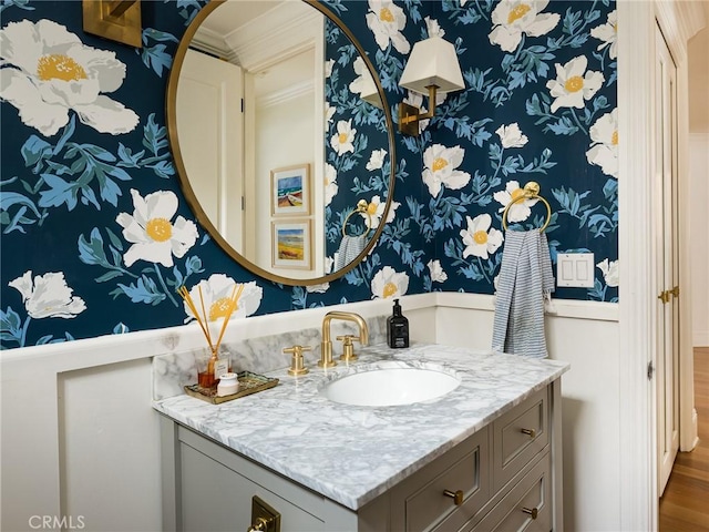 bathroom with vanity and wallpapered walls