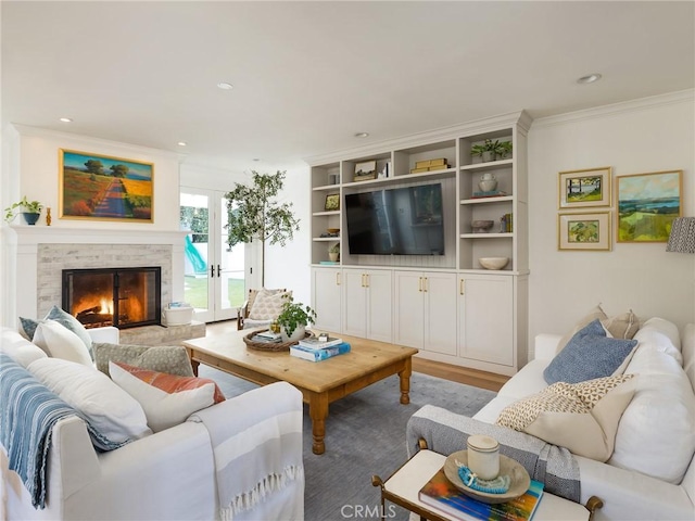 living room with crown molding, recessed lighting, wood finished floors, and a fireplace