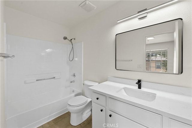 bathroom with vanity, tile patterned floors, shower / bathtub combination, and toilet