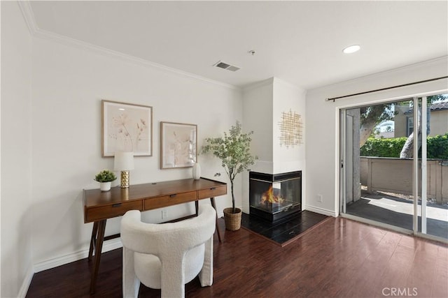 interior space featuring visible vents, baseboards, crown molding, and wood finished floors