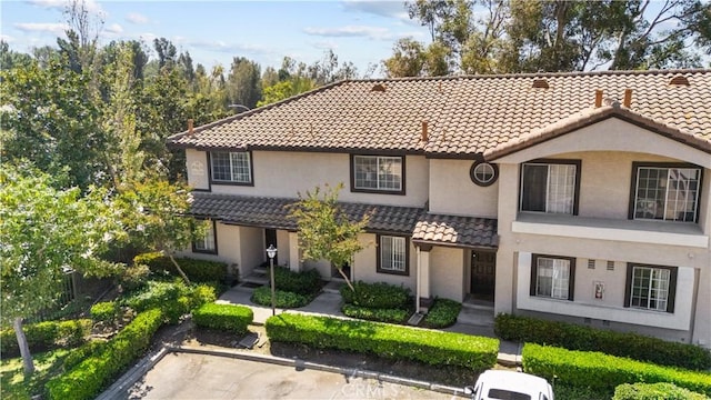 12584 Atwood Ct Unit 1215, Rancho Cucamonga, CA 91739 - view of front of home with a tile roof and stucco siding