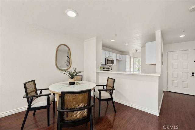 dining space with recessed lighting, baseboards, and dark wood-style floors