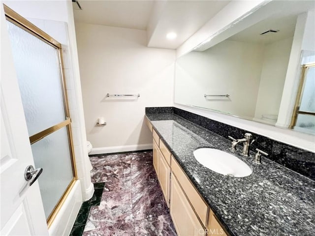 6926 Orozco Dr, Riverside, CA 92506 - bathroom with vanity, baseboards, bath / shower combo with glass door, toilet, and marble finish floor